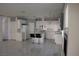 Open-concept kitchen with white cabinets, tile flooring, and a center island for casual dining at 8982 Emerald Waters Ct, Las Vegas, NV 89147