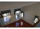 A bright living room with large windows and hardwood floors, as seen from the upper level at 8982 Emerald Waters Ct, Las Vegas, NV 89147