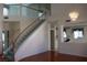 A spacious living room featuring a staircase and an elegant chandelier at 8982 Emerald Waters Ct, Las Vegas, NV 89147
