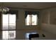 Spacious living room with tile flooring, backyard access, and two large windows at 8982 Emerald Waters Ct, Las Vegas, NV 89147