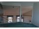 Bright loft area featuring a wooden railing, overlooking the living space with lots of natural light at 8982 Emerald Waters Ct, Las Vegas, NV 89147