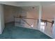 Bright loft area with neutral walls and railing overlooking the floor below at 8982 Emerald Waters Ct, Las Vegas, NV 89147