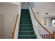 View of carpeted stairs with white risers and a wood railing leading to the upper level at 8982 Emerald Waters Ct, Las Vegas, NV 89147