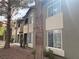 Exterior shot of building with tan and gray stucco, dark trim, and mature trees at 9000 Las Vegas Blvd # 1271, Las Vegas, NV 89123