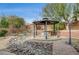 Serene backyard featuring a charming gazebo, rock garden, and lush landscaping at 9092 National Park Dr, Las Vegas, NV 89178