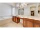 Bright bathroom featuring dual vanities, soaking tub, and walk-in closet at 9092 National Park Dr, Las Vegas, NV 89178
