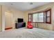 Bedroom with natural light from a large shuttered window and modern furniture at 9092 National Park Dr, Las Vegas, NV 89178