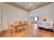Open dining space with hardwood floors, a wood table with chairs, and access to the living room at 9092 National Park Dr, Las Vegas, NV 89178