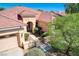 Charming home featuring a well-manicured front yard, arched entryway, and attached garage at 9092 National Park Dr, Las Vegas, NV 89178