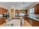 Kitchen with stainless steel appliances, cherry cabinets, and granite countertops at 9092 National Park Dr, Las Vegas, NV 89178