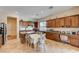 Eat-in kitchen area with stainless steel appliances and cherry wood cabinetry at 9092 National Park Dr, Las Vegas, NV 89178