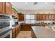 Eat-in kitchen showcasing stainless appliances, cherry cabinets, and an island at 9092 National Park Dr, Las Vegas, NV 89178