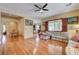 Bright and open living room with hardwood floors adjacent to the kitchen at 9092 National Park Dr, Las Vegas, NV 89178