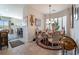 Charming dining area with elegant chandelier, decorative glass blocks, and access to living areas at 9165 Tudor Park Pl, Las Vegas, NV 89145