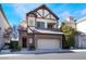 Charming two-story home features a stone facade, attached two-car garage, and well-maintained landscaping at 9165 Tudor Park Pl, Las Vegas, NV 89145
