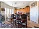 Bright kitchen with granite countertops, stainless appliances, wooden cabinetry, and breakfast bar seating at 9165 Tudor Park Pl, Las Vegas, NV 89145