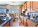 Bright kitchen with granite countertops, stainless appliances, wooden cabinetry, and a breakfast nook with a view at 9165 Tudor Park Pl, Las Vegas, NV 89145