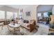 Comfortable living room featuring fireplace, plush seating, and connecting staircase at 9165 Tudor Park Pl, Las Vegas, NV 89145