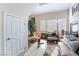 Cozy living room with comfortable seating and ample natural light from the bright windows at 9165 Tudor Park Pl, Las Vegas, NV 89145