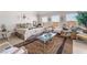 Bright main bedroom with dual windows, decorative bedding, and seating at 9165 Tudor Park Pl, Las Vegas, NV 89145