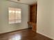 This bedroom features wood flooring, a window, and a built-in desk with shelving at 9236 Canalino Dr, Las Vegas, NV 89134