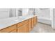 Bright bathroom featuring double sinks, light wood cabinets, modern fixtures and a tub at 9788 Altadena St, Las Vegas, NV 89183