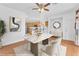 Staged dining room with stylish furnishings, hardwood floors, with adjacent kitchen, and bright natural light at 9788 Altadena St, Las Vegas, NV 89183