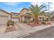 Charming two-story home with a well-manicured lawn and a large palm tree in the front yard at 9788 Altadena St, Las Vegas, NV 89183