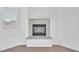 Fireplace detail, with tile surround and a bright window, in a neutral colored living room at 9788 Altadena St, Las Vegas, NV 89183