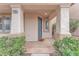 Inviting front entrance featuring a secure door, decorative columns, and well-maintained landscaping at 9788 Altadena St, Las Vegas, NV 89183