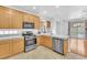 Well-lit kitchen featuring stainless steel appliances, light wood cabinets, and white marble countertops at 9788 Altadena St, Las Vegas, NV 89183