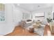 Staged living room with stylish furnishings, hardwood floors, and bright natural light at 9788 Altadena St, Las Vegas, NV 89183