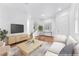 Staged living room with stylish furnishings, hardwood floors, staircase, and bright natural light at 9788 Altadena St, Las Vegas, NV 89183