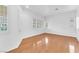 Bright and airy living room with hardwood floors and ample natural light from multiple windows at 9788 Altadena St, Las Vegas, NV 89183