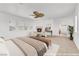 Staged main bedroom with a fireplace, neutral carpet, large windows, ceiling fan and tasteful decor at 9788 Altadena St, Las Vegas, NV 89183