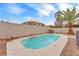 A rectangular inground pool is surrounded by desert landscaping and framed by a stucco wall at 9788 Altadena St, Las Vegas, NV 89183