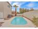 A private, fenced in backyard featuring a refreshing pool and mature palm tree for shade at 9788 Altadena St, Las Vegas, NV 89183