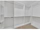 Bright walk-in closet featuring custom white shelving and metal rods to organize clothes at 1026 Via Saint Andrea Pl, Henderson, NV 89011