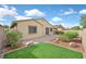 Landscaped backyard with an area of artificial grass and a paved patio at 1026 Via Saint Andrea Pl, Henderson, NV 89011