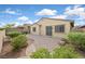 Property with neat landscaping, paved patio, and an area of artificial grass at 1026 Via Saint Andrea Pl, Henderson, NV 89011