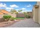 Paved patio with a small area of artificial grass and neat landscaping at 1026 Via Saint Andrea Pl, Henderson, NV 89011