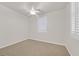 Neutral bedroom with a ceiling fan and a window with shutters at 1026 Via Saint Andrea Pl, Henderson, NV 89011