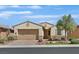 Charming single-story home featuring a manicured front yard, brick driveway, and a two-car garage at 1026 Via Saint Andrea Pl, Henderson, NV 89011