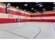 Spacious gymnasium with basketball hoops, ample lighting, and marked court lines at 1026 Via Saint Andrea Pl, Henderson, NV 89011