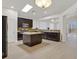 Spacious kitchen with stainless steel appliances, granite countertops, central island, and ample natural light at 1026 Via Saint Andrea Pl, Henderson, NV 89011