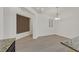 Open living area with wood-look floors, bright lighting, and neutral wall color at 1026 Via Saint Andrea Pl, Henderson, NV 89011