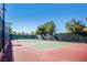 Outdoor tennis court with net and fencing, perfect for recreational play and exercise at 1026 Via Saint Andrea Pl, Henderson, NV 89011