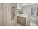 Modern bathroom with a sleek vanity, vessel sink, and shower-tub combination at 10270 Gilmore Canyon Ct # 202, Las Vegas, NV 89129