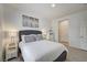 Well-lit bedroom featuring a queen bed, bedside tables, and convenient closet access at 10270 Gilmore Canyon Ct # 202, Las Vegas, NV 89129