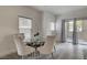 Dining area featuring a glass-top table, comfortable seating, and sliding glass doors at 10270 Gilmore Canyon Ct # 202, Las Vegas, NV 89129